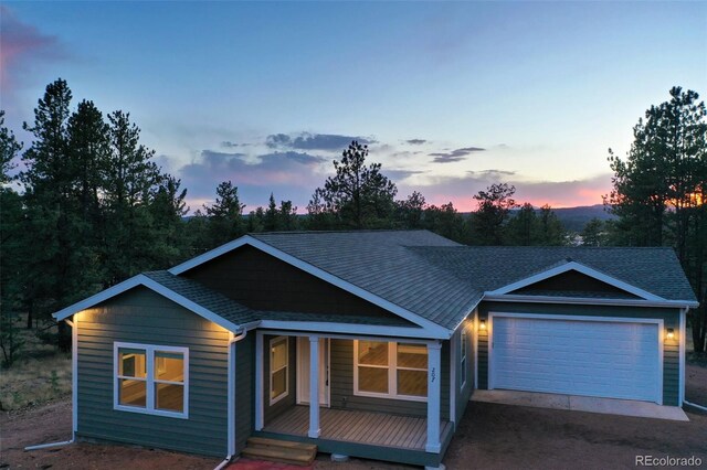 view of front of home featuring a garage and covered porch