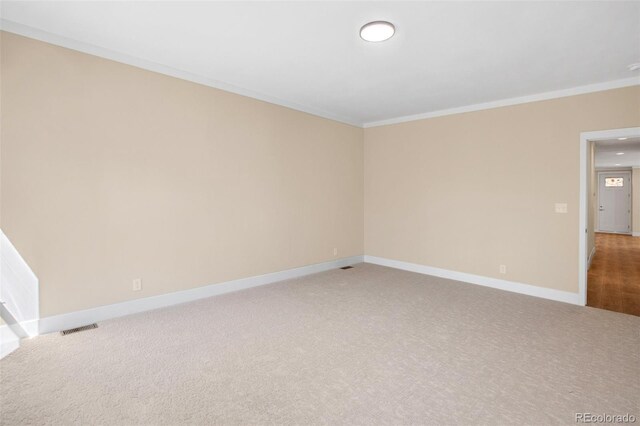 carpeted spare room with ornamental molding