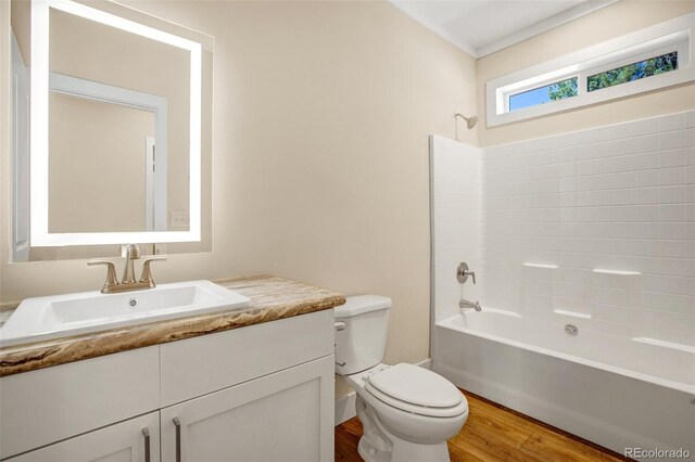 full bathroom with shower / bathing tub combination, wood-type flooring, vanity, and toilet