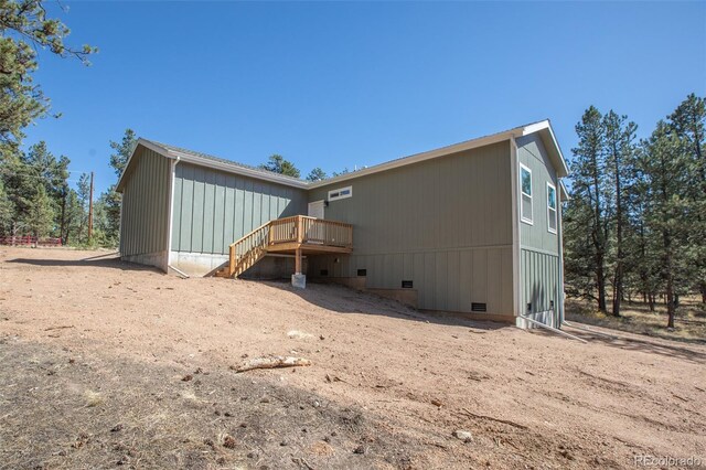 back of property featuring a wooden deck