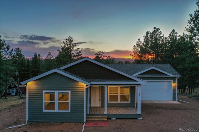 view of front of property featuring a garage and a porch