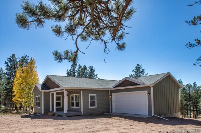 ranch-style house with a garage and covered porch