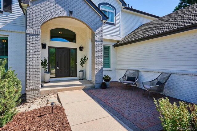 property entrance featuring brick siding
