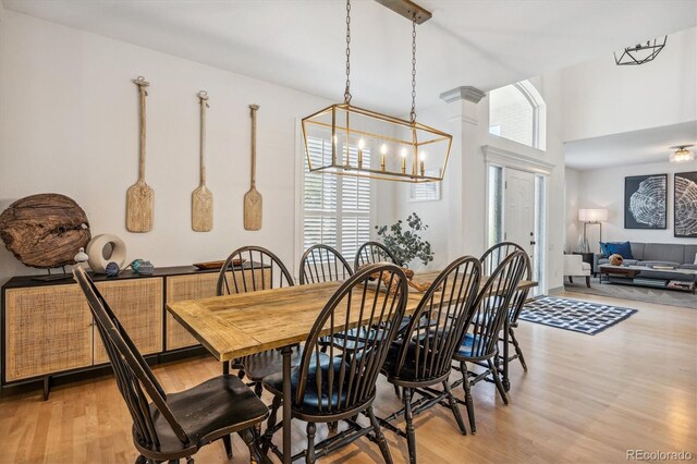 dining room featuring light wood-style floors and a chandelier