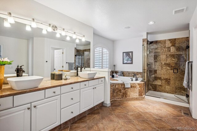 full bathroom with a garden tub, a stall shower, double vanity, and recessed lighting