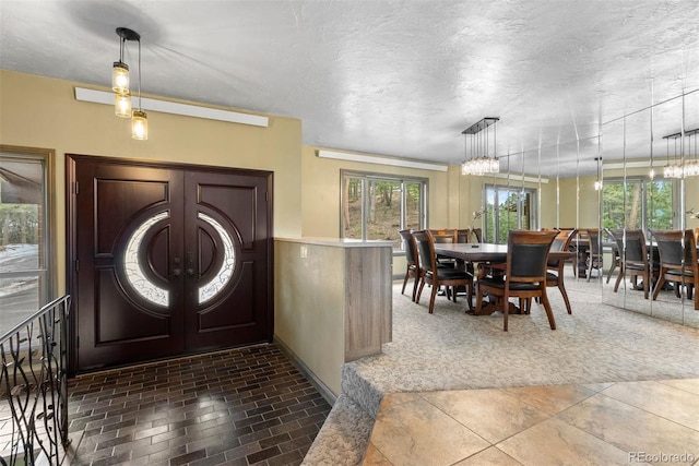 foyer featuring french doors and a textured ceiling