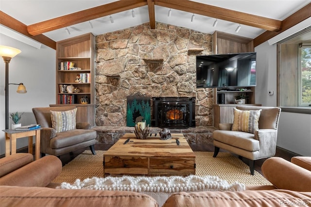 living room featuring a stone fireplace and vaulted ceiling with beams