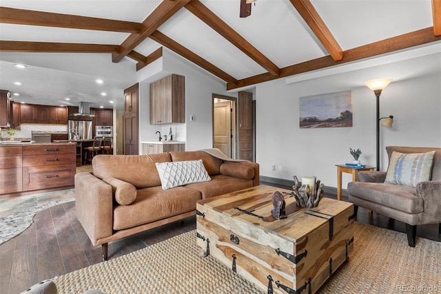 living room with dark hardwood / wood-style flooring and vaulted ceiling with beams