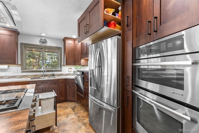 kitchen with sink, decorative backsplash, and appliances with stainless steel finishes