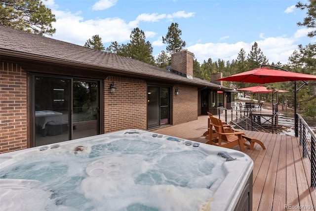 wooden deck featuring a hot tub