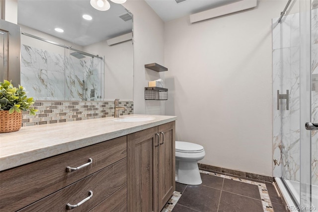 bathroom with vanity, toilet, an enclosed shower, and backsplash