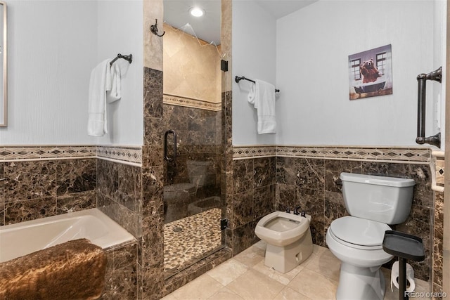 bathroom with separate shower and tub, a bidet, tile patterned flooring, toilet, and tile walls