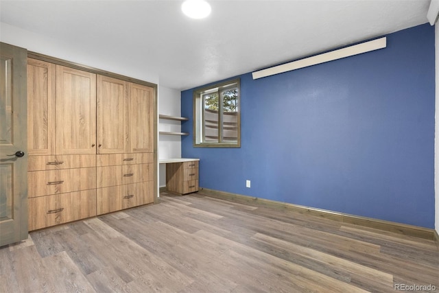 unfurnished bedroom featuring light wood-type flooring