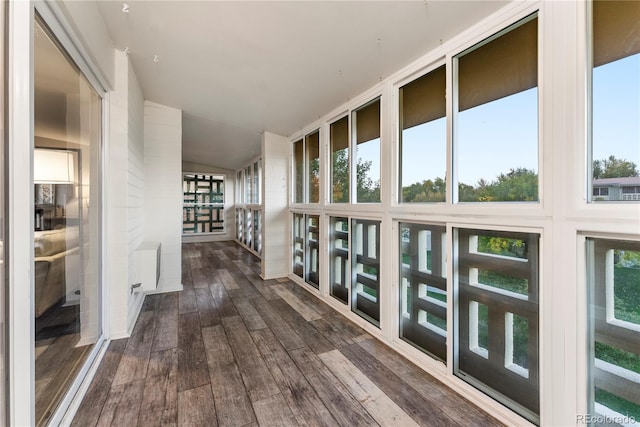 hallway with lofted ceiling and dark hardwood / wood-style floors