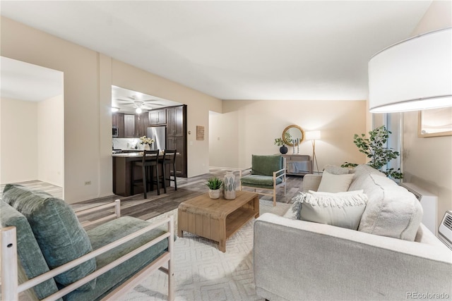 living room with ceiling fan and hardwood / wood-style floors