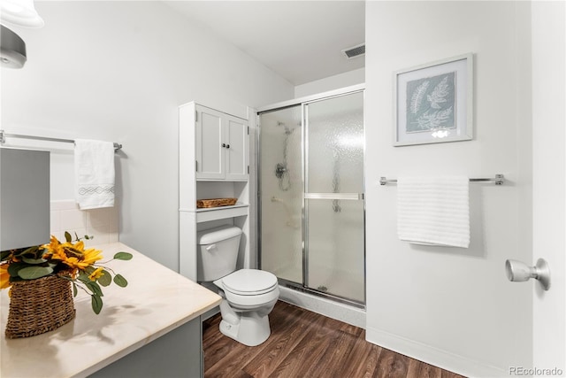 bathroom with walk in shower, toilet, vanity, and hardwood / wood-style flooring