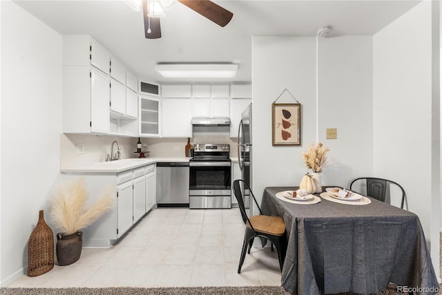 kitchen with sink, white cabinetry, ceiling fan, decorative backsplash, and appliances with stainless steel finishes