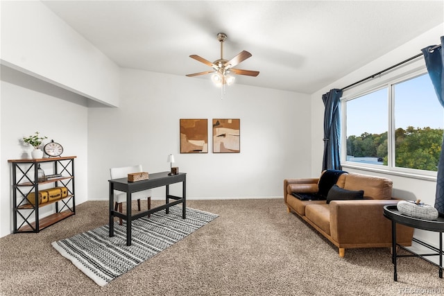 carpeted office with vaulted ceiling and ceiling fan