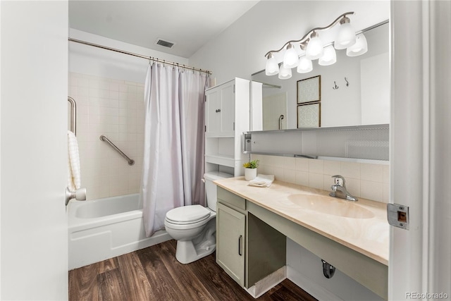 full bathroom with toilet, decorative backsplash, hardwood / wood-style floors, shower / tub combo, and vanity