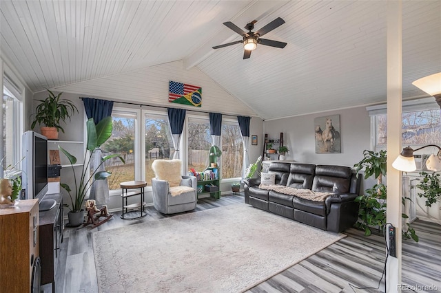 living room with a ceiling fan, lofted ceiling with beams, and wood finished floors