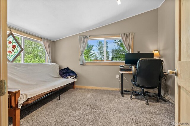 home office with vaulted ceiling, healthy amount of natural light, carpet flooring, and baseboards