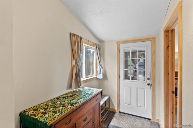 entryway with vaulted ceiling and baseboards