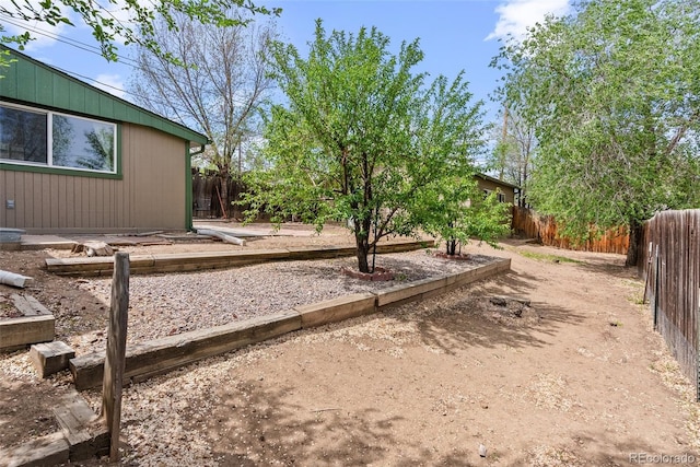fenced backyard with a vegetable garden