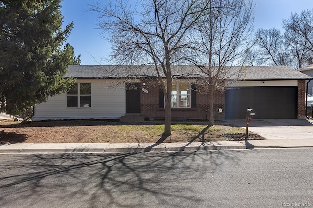 ranch-style house featuring brick siding, an attached garage, and driveway