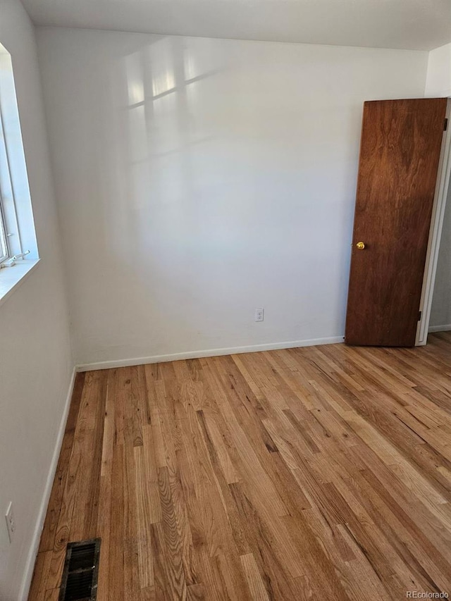 unfurnished room with light wood-type flooring