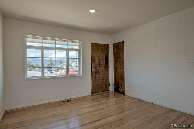 unfurnished room featuring light hardwood / wood-style floors