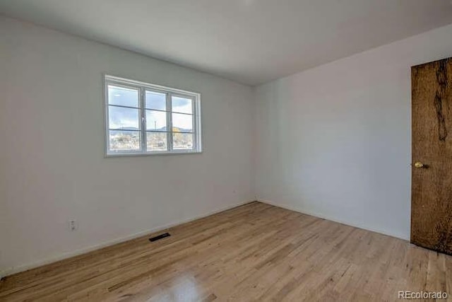 unfurnished room featuring light wood-type flooring