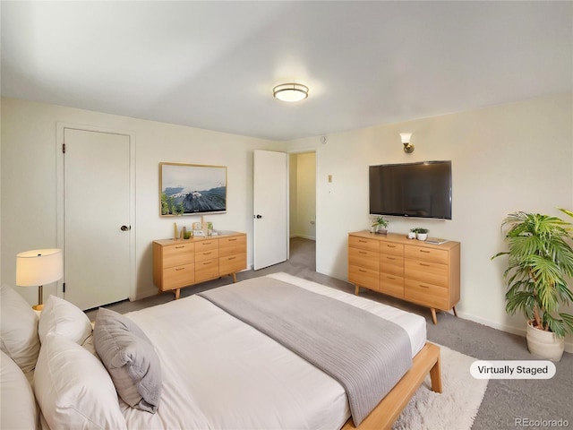 bedroom with baseboards and light carpet