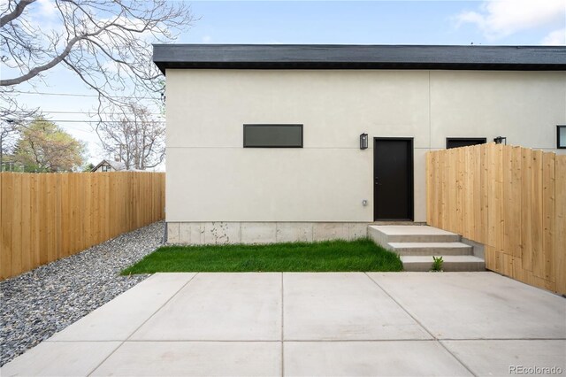 2520 S Cherokee St, Denver, CO 80223 - back of property featuring a patio area, stucco siding, and fence
