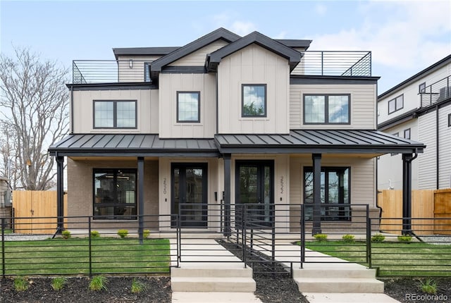 2520 S Cherokee St, Denver, CO 80223 - modern farmhouse featuring metal roof, a porch, a standing seam roof, and a fenced front yard