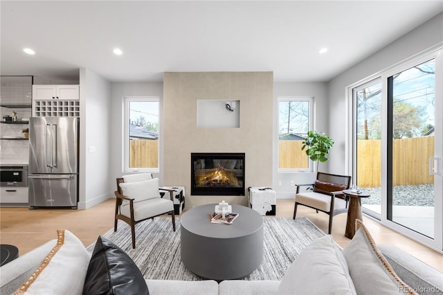 2520 S Cherokee St, Denver, CO 80223 - living room with light wood-style floors, a fireplace, baseboards, and recessed lighting