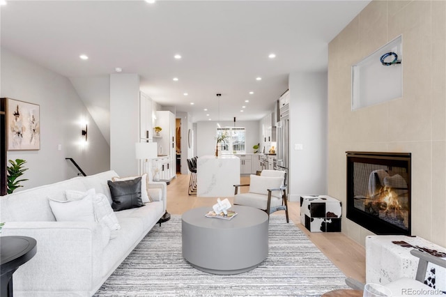 2520 S Cherokee St, Denver, CO 80223 - living area featuring light wood finished floors, a glass covered fireplace, and recessed lighting