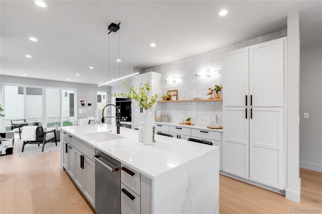 2520 S Cherokee St, Denver, CO 80223 - kitchen with recessed lighting, dishwasher, a sink, tasteful backsplash, and light wood-type flooring