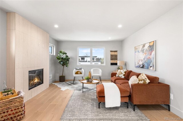 2520 S Cherokee St, Denver, CO 80223 - living area featuring light wood-style flooring, baseboards, recessed lighting, and a tile fireplace