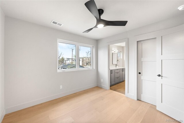2520 S Cherokee St, Denver, CO 80223 - unfurnished bedroom with light wood-style flooring, a closet, ensuite bathroom, visible vents, and baseboards