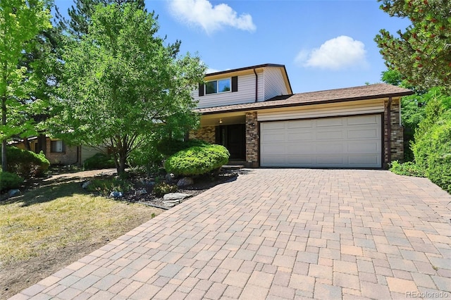 802 Altair Dr, Littleton, CO 80124 - view of front facade featuring a garage, brick siding, and decorative driveway