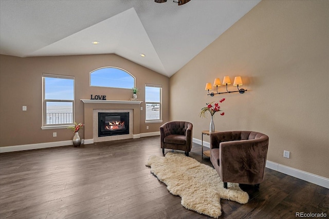 sitting room featuring a fireplace, plenty of natural light, dark hardwood / wood-style flooring, and vaulted ceiling