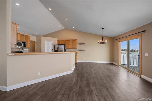 kitchen with appliances with stainless steel finishes, pendant lighting, dark hardwood / wood-style flooring, and kitchen peninsula