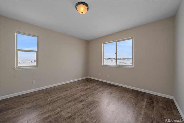 unfurnished room with dark wood-type flooring