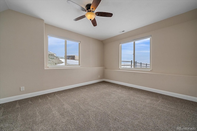 carpeted empty room with vaulted ceiling and ceiling fan