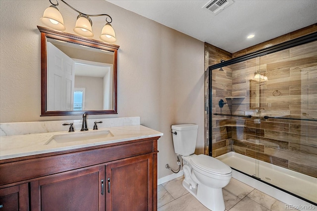 bathroom featuring vanity, an enclosed shower, and toilet