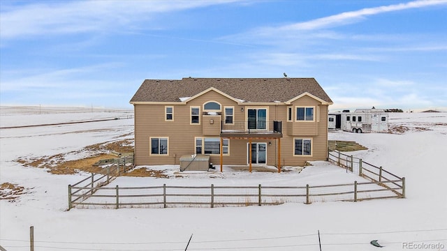 view of snow covered rear of property