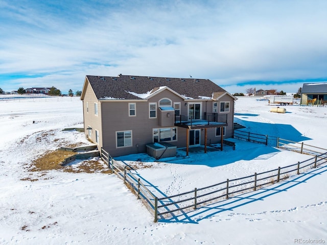 view of snow covered rear of property