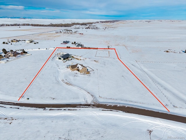 snowy aerial view with a rural view