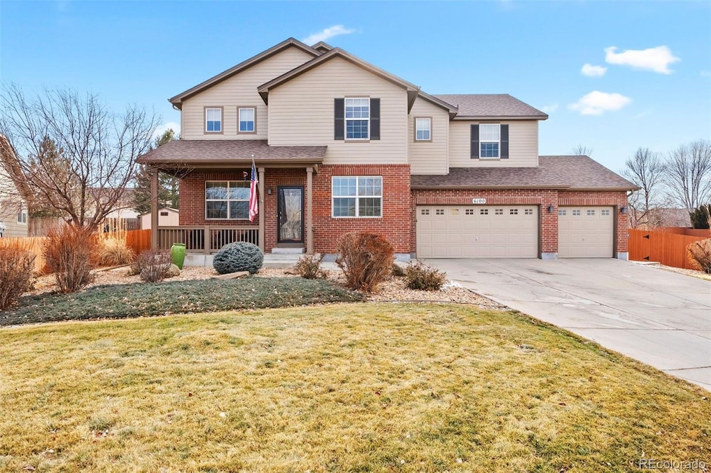 view of front of house with a porch, a garage, and a front lawn