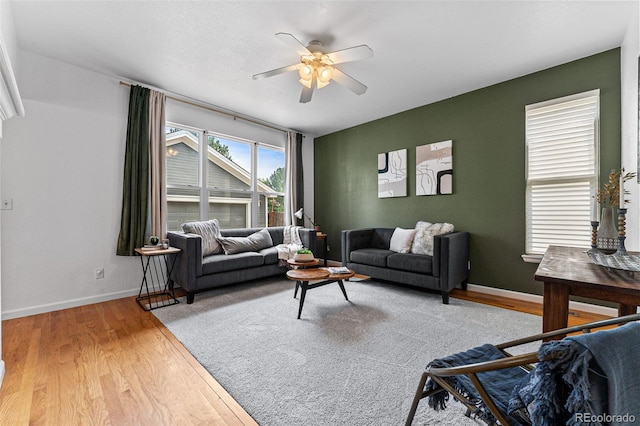 living room with ceiling fan and light hardwood / wood-style floors